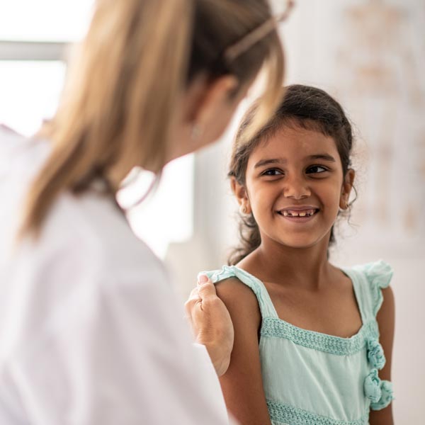 little girl smiling at the doctor